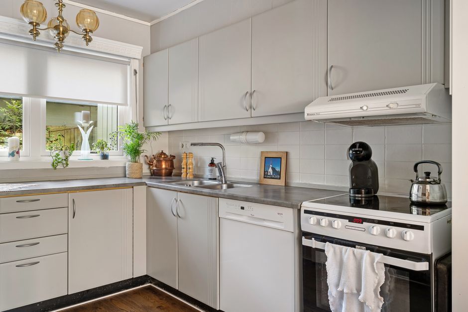 Clean and stylish modern kitchen with white cabinets and stainless steel appliances.