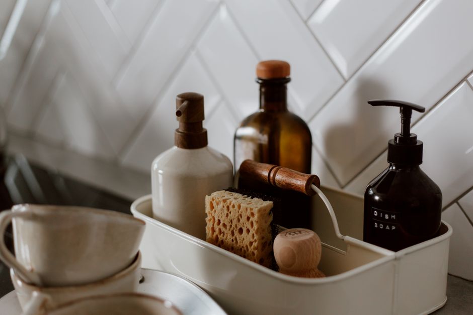 Close-up of chic kitchen cleaning essentials on a stylish countertop.